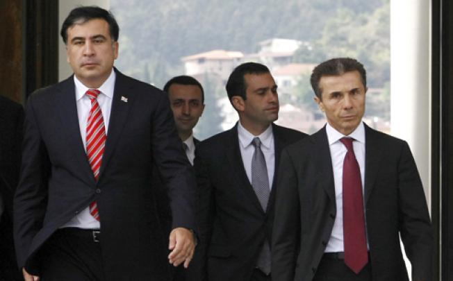 Georgian President Mikhail Saakashvili (left) and Bidzina Ivanishvili (right) the likely new prime minister, go to meet the press before their meeting at the Presidential Palace in Tbilisi, on Tuesday. Photo: AP