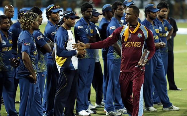  West Indies' cricketer Marlon Samuels greats Sri Lankan team members after winning the ICC Twenty20 Cricket World Cup in Colombo on Sunday. Photo: AFP