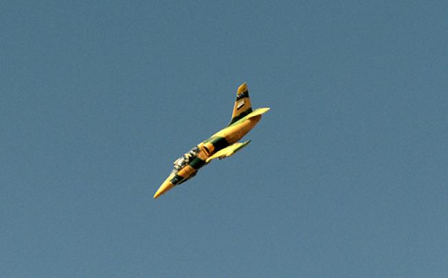 A Syrian army fighter jet flies over the northern city of Aleppo on Saturday. Photo: AFP