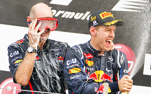 Red Bull technical officer Adrian Newey (left) and German Sebastian Vettel celebrate their win with champagne on Sunday. Photo: EPA