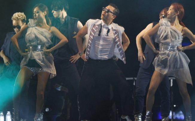 South Korean rapper Psy (centre) has topped the charts in the United States and Britain with Gangnam Style, which has brought massive exposure to K-Pop and introduced the wider world to the genre.