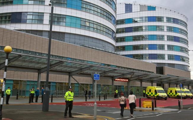 Police officers stand guard around the Queen Elizabeth Hospital in Birmingham where 14-year-old Malala Yusufza arrived for treatment on Monday. Photo: EPA
