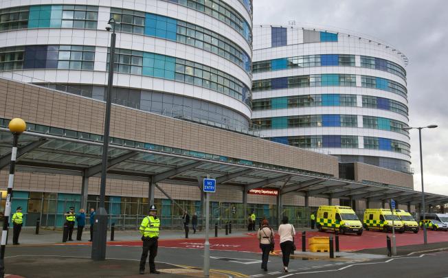 Police officers stand guard around the Queen Elizabeth Hospital in Birmingham where 14-year old Malala is being treated. Photo: EPA