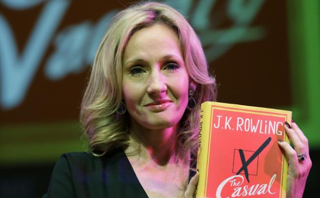 British writer JK Rowling poses with her new book <i>The Casual Vacancy</i> on September 27. The book is Rowling's first novel for adults. Photo: AP