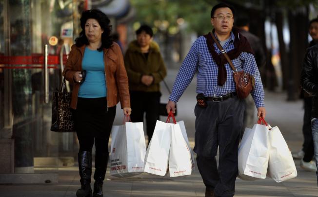 Shoppers in Beijing. China's industrial production and exports have disappointed but domestic demand is holding up. Photo: AFP