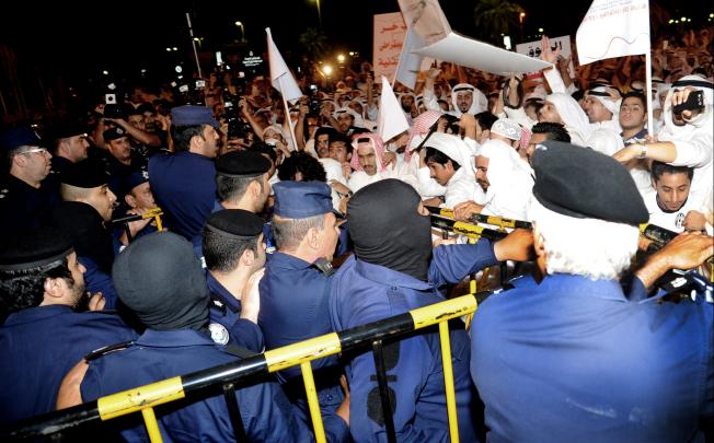Kuwaitis protest in Erada Square in Kuwait on Monday. Photo: AP