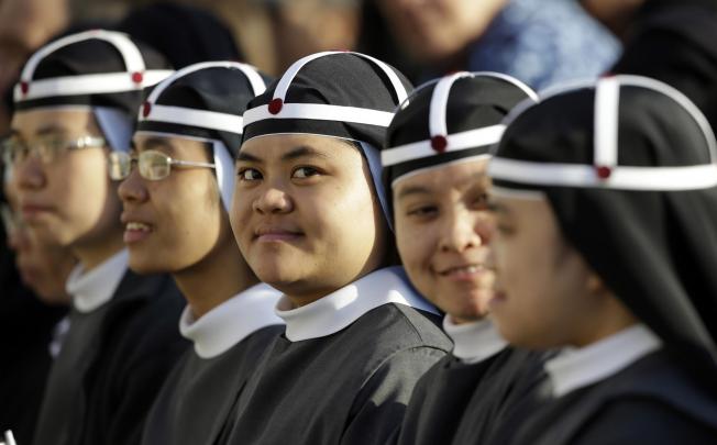 Filipino nuns attend the canonisation of seven people, including Pedro Calungsod. Photo: AP