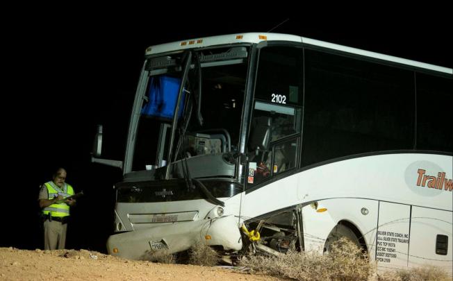 An Arizona Highway Patrol officer examines the tour bus that crashed on its way from the Grand Canyon to Las Vegas. Photo: AP