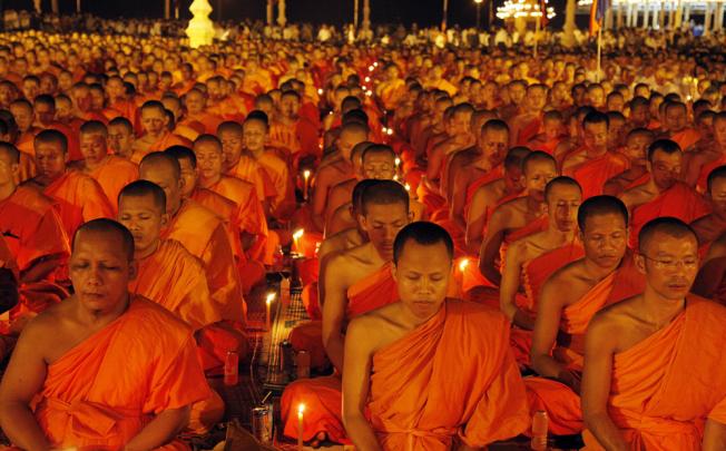Cambodian Buddhists pray for the soul of late King-Father Norodom Sihanouk in front of the Royal Palace in Phnom Penh, Cambodia.