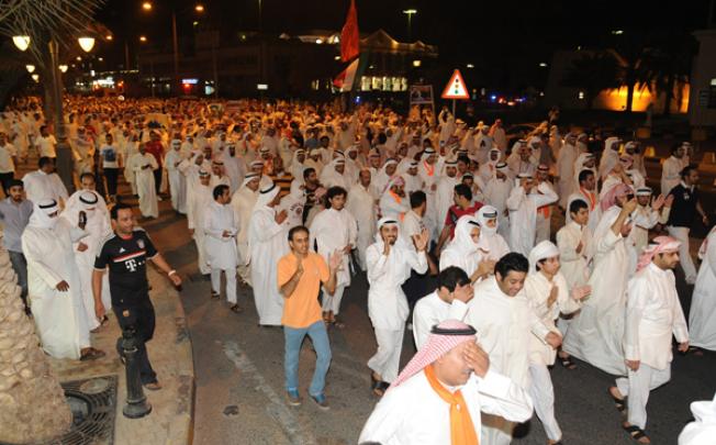 Kuwaiti opposition supporters march during a demonstration in Kuwait on Sunday. Photo: EPA