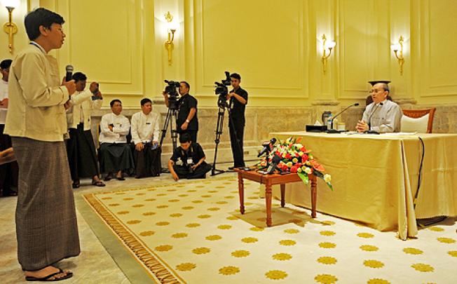 Myanmar President Thein Sein (right) answers a question from a journalist during a press conference in Naypyidaw on Sunday. Photo: AFP