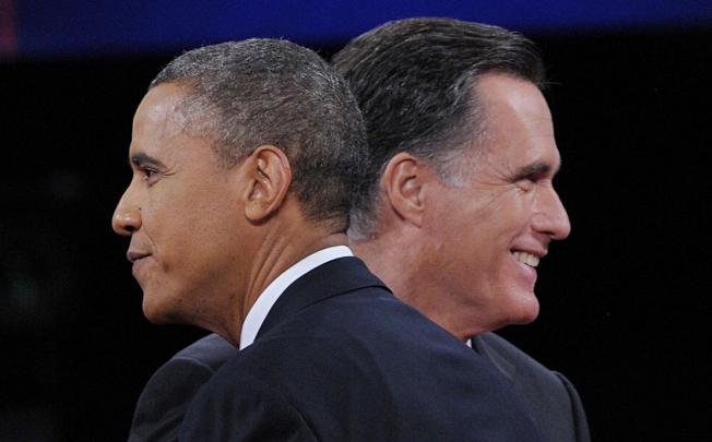 Obama greets Romney at the end of their debate. By then, Romney seemed eager to leave. Photo: AFP