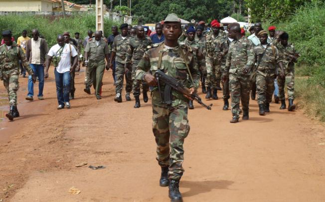 Soldiers walk on a street in Bissau after gunmen raided a Guinea-Bissau army barracks in the capital, sparking a firefight that left at least seven people dead. Photo: AFP