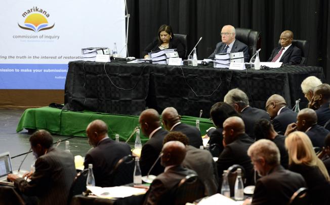 Members of the commission sit during the reopening of the Marikana commission of inquiry into the police killing of 34 striking miners and related violence in August. Photo: AFP 