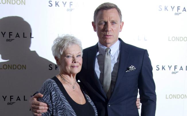 Judi Dench and Daniel Craig pose for photographs at the <i>Skyfall</i> photo call at the Dorchester Hotel in London on October 22. Photo: AP