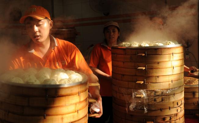 Steamed buns are sold for breakfast at a store in Shanghai. The latest HSBC PMI data points to slight improvement in the world’s second largest economy. Photo: AFP 
