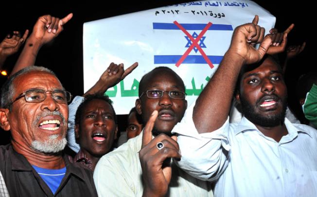Sudanese demonstrators hold banners and chant anti-Israeli slogans during a protest in Khartoum on Wednesday. Photo: AFP