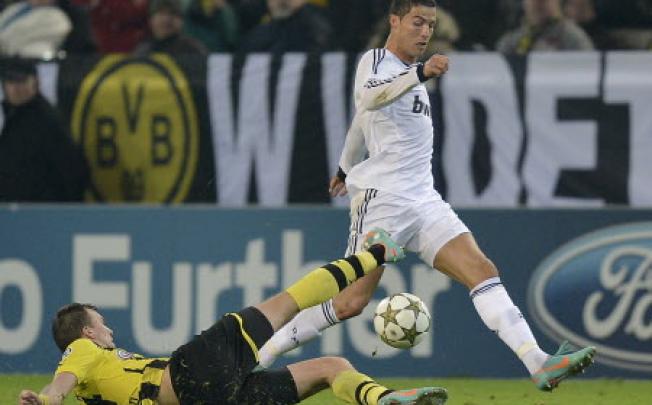 Real's Cristiano Ronaldo, right, and Dortmund's Kevin Grosskreutz challenge for the ball during the Champions League Group D soccer match between Borussia Dortmund and Real Madrid in Dortmund on Wednesday. Photo: AFP
