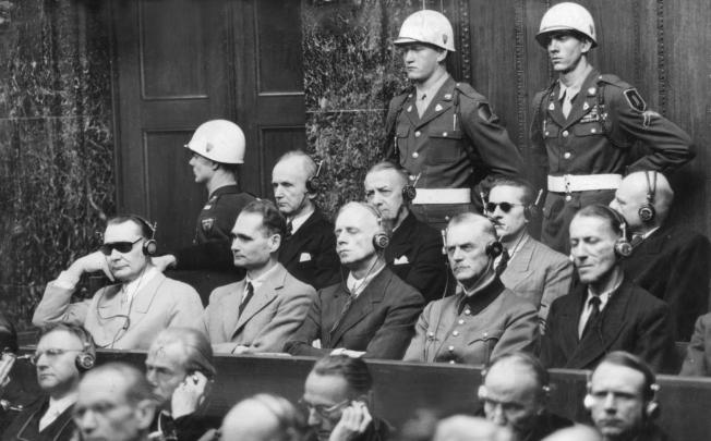 Hermann Göring (left, in dark glasses) sits beside Hermann Hesse and other top Nazis at their trial in Nuremberg. Photo: Keystone
