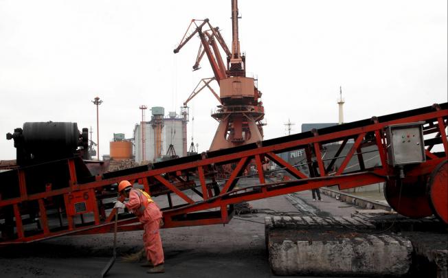Coal being loaded at a dock in Shanghai. China Shenhua Energy's sales rose but they were offset by lower selling prices. Photo: Bloomberg