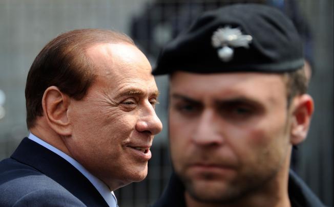 Former Italian prime minister Silvio Berlusconi (left) has been sentenced by a Milan court to four years in prison for tax fraud. Photo: AFP
