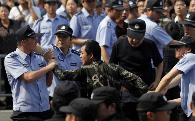 Police arrest a demonstrator. Photo: Reuters