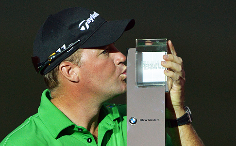 Peter Hanson of Sweden kisses his BMW Masters trophy in Shanghai on Sunday. Photo: AFP