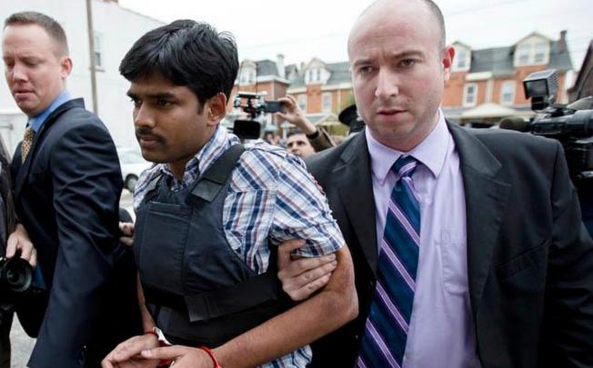 Raghunandan Yandamuri is led into court in a bullet-proof vest.