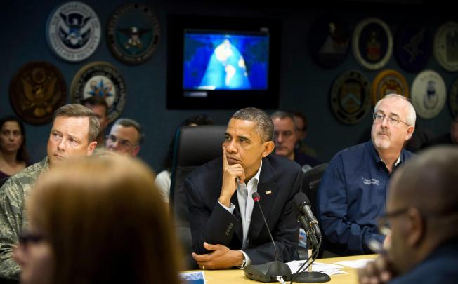 US President Barack Obama receives a briefing on the hurricane at the Federal Emergency Management Agency in Washington on Sunday. Photo: AFP