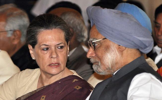 Indian Prime Minister Manmohan Singh (right) and Congress party head Sonia Gandhi speak at the swearing-in ceremony for the new ministers. Photo: EPA