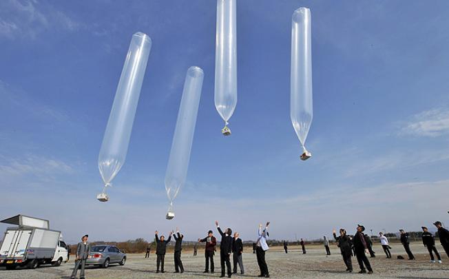 South Korean activists release balloons carrying anti-North Korea leaflets at a park in the border town of Paju, north of Seoul on Monday. Photo: AFP