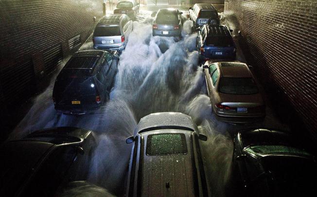 Water rushes into an underground parking garage in New York's financial district. Photo: AFP