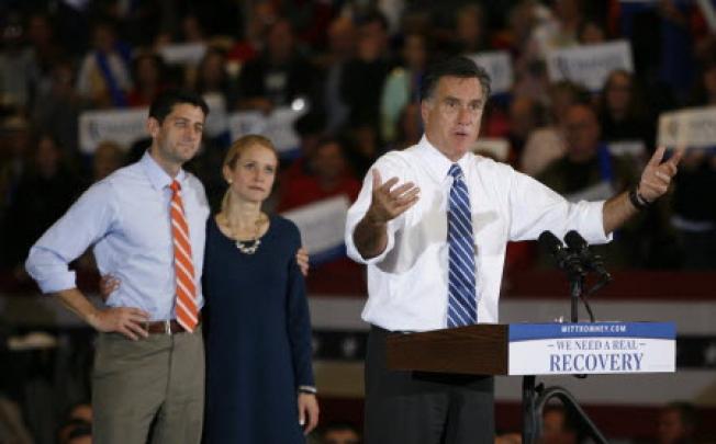 Republican presidential candidate Mitt Romney Paul Ryan and his wife Janna at a campaign rally in Marion, Ohio. The storm on the East Coast caused Romney to join Ryan at the campaign stop in Ohio. Photo: AP