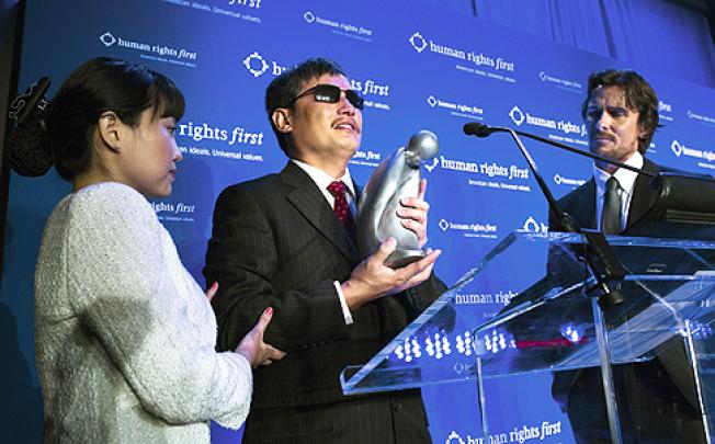 Activist Chen Guangcheng (centre) receives the Human Rights First prize in New York last week. Photo: AP