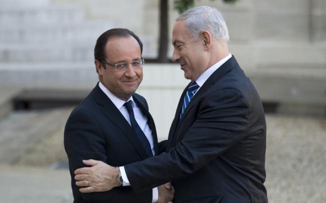 French President Francois Hollande (left) welcomes Israel's Prime Minister Benjamin Netanyahu on Wednesday at the Elysee Palace in Paris. Photo: AFP