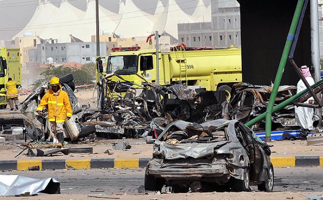 Saudi rescue workers inspect the site where a truck transporting gas exploded in Riyadh. Photo: AFP