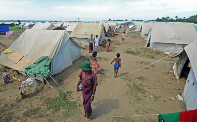 Muslim Rohingya people walk around the Bawdupha Internally Displaced Persons (IDP) camp on the outskirts of Sittwe, western Rakhine state on Friday. Photo: AFP