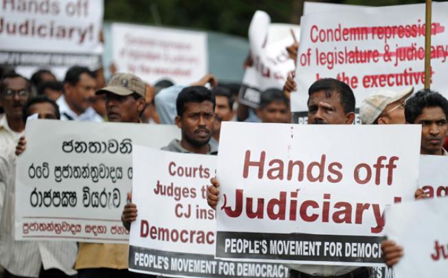 Sri Lankan lawyers and opposition activists demonstrate outside the Supreme Court in Colombo on Monday. Photo: AFP