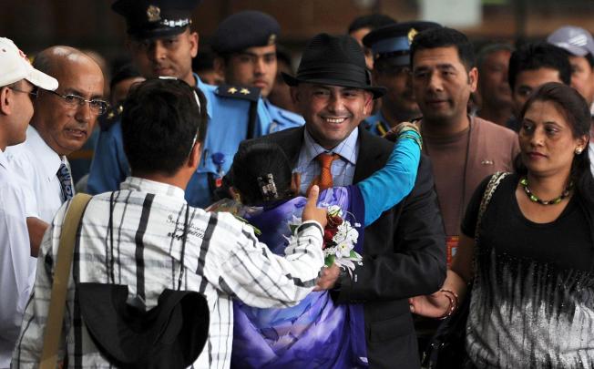 Chandrakala Mainali welcomes home her son. Photo: AFP