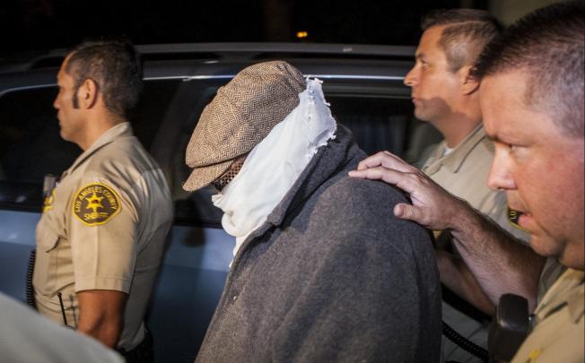 Mark Basseley Youssef is escorted from his home by Los Angeles County Sheriff's officers on September 15. Photo: Reuters