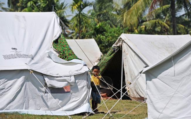 A Ethnic Rakhine child stands beside a tent in Mayebon Internally Displaced Persons (IDP) camp in Rakhine state on November 1. Photo: AFP