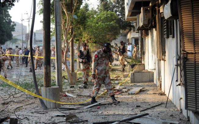 Pakistani security personnel are pictured at the scene of a suicide bomb attack at the Rangers complex in Karachi on Thursday. Photo: AFP