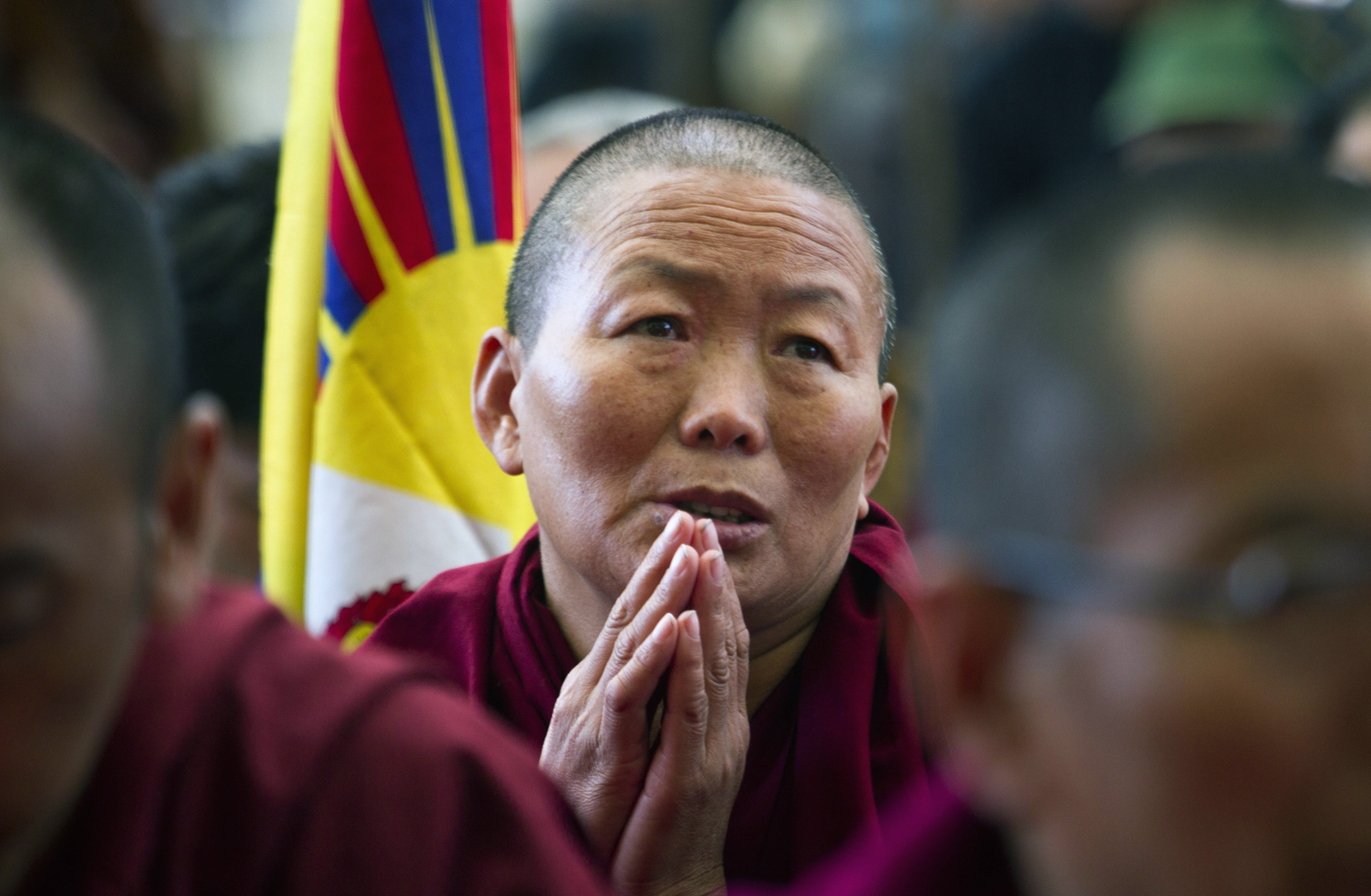 An exiled Tibetan Buddhist nun in Dharamsala,India, prays in solidarity with Tibetans who have self-immolated in China. Photo: AP 