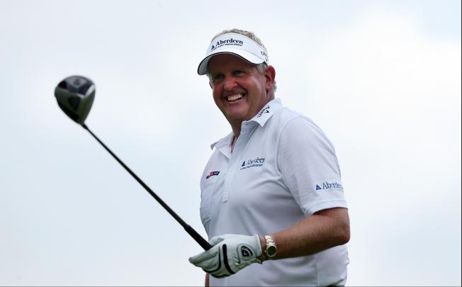 Colin Montgomerie of Scotland tees off on the ninth hole during the second round of the Singapore Open golf tournament at the Serapong Course at Sentosa Golf Club in Singapore on Saturday Nov. 10, 2012. Photo: AP+
