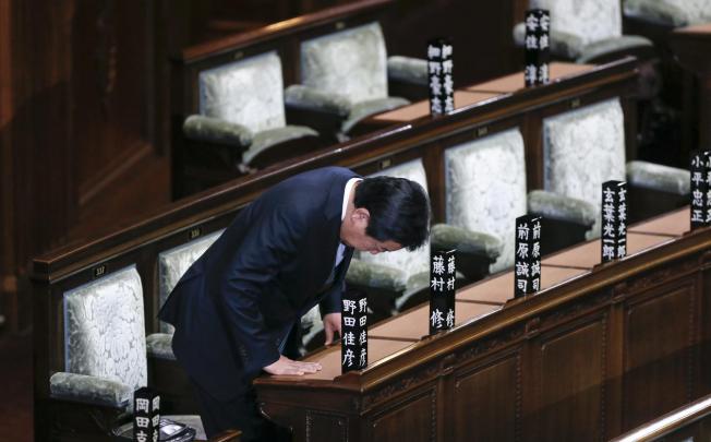 Yoshihiko Noda bows as he takes his seat in Japan's lower house chamber yesterday. Photo: EPA