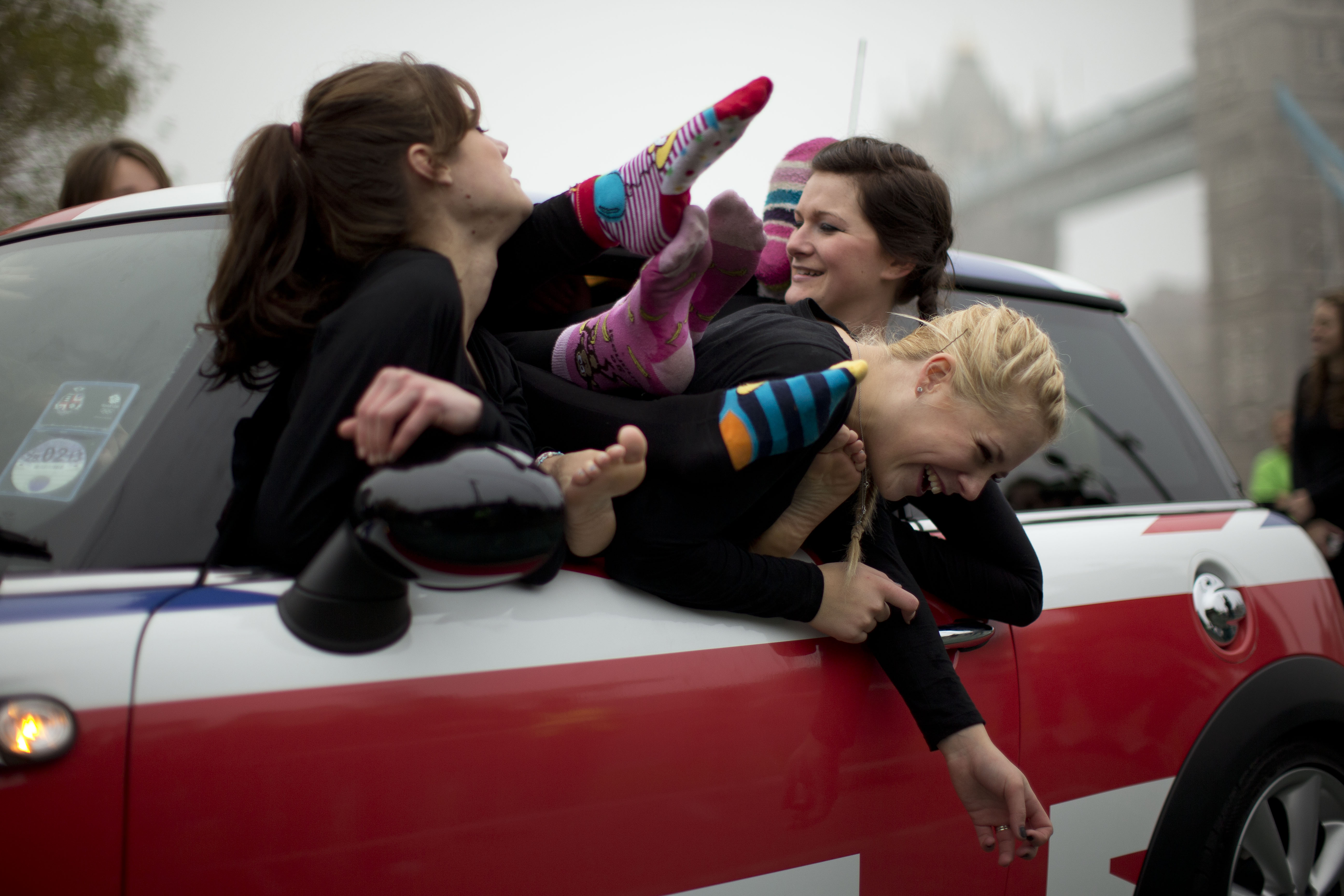 A group of women ham it up for the media after they set a new Guinness World Record by squashing 28 people into a Mini in London. Photo: AP