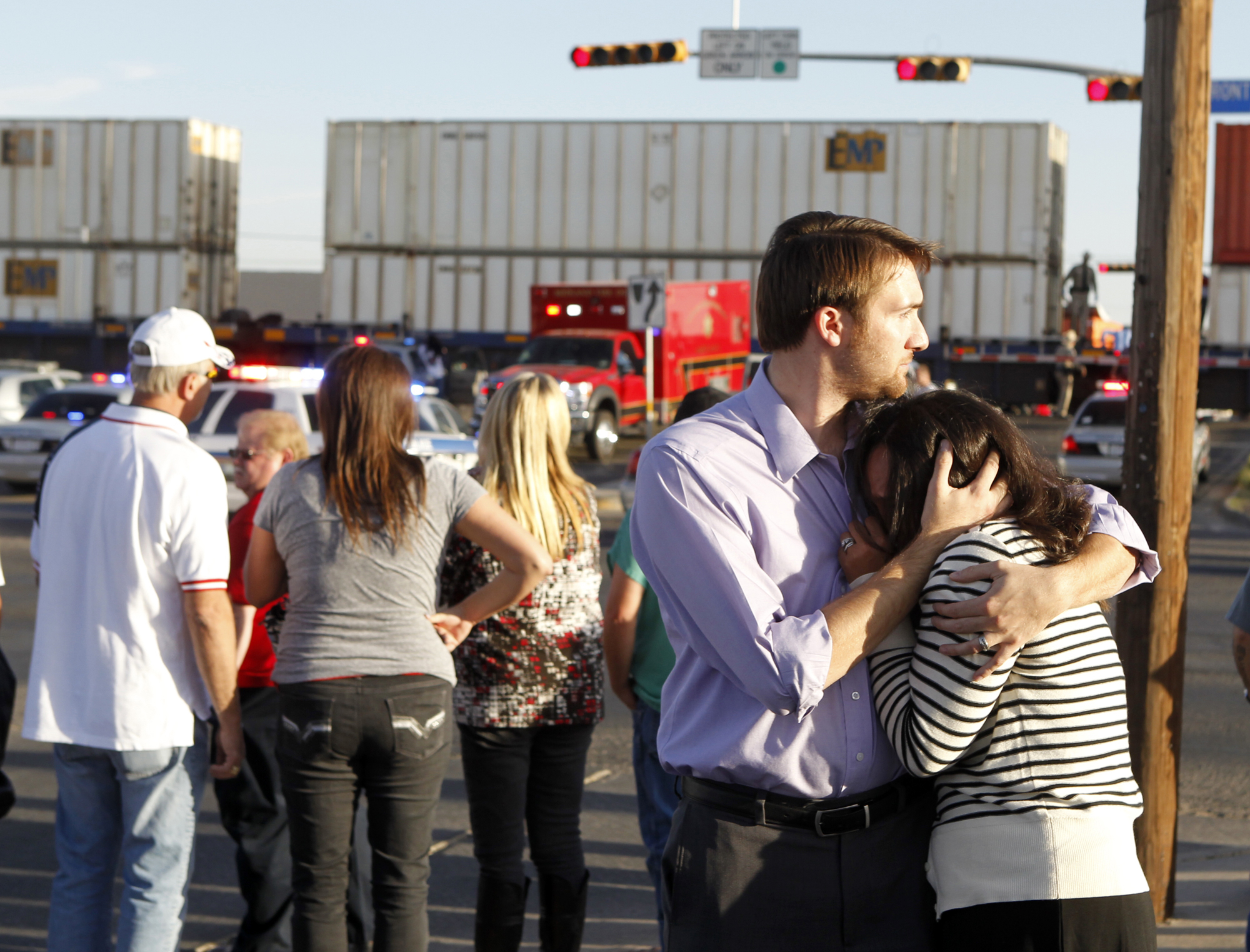 Bystanders comfort each other after a train crashed into a parade float carrying veterans in Midland, Texas, on Thursday. Photo: AP