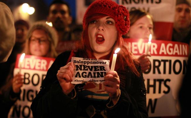 Demonstrators hold placards and candles in memory of Indian Savita Halappanavar who died after being refused an abortion. Photo:AFP