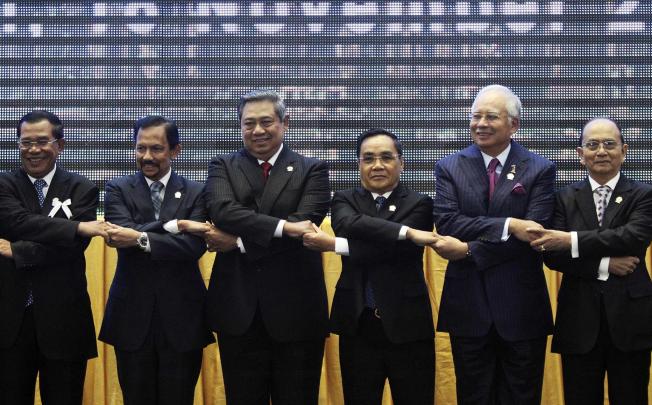 Asean leaders hold hands during the opening ceremony of the 21st Asean and East Asia summits in Phnom Penh. Photo: Reuters