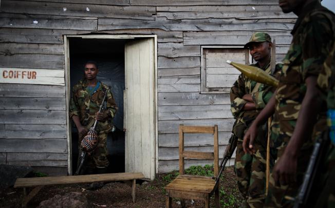 M23 rebels stand outside a small wooden shack in the village of Kanyarucinya, some 6km from Goma, a crucial provincial capital in eastern Congo. Photo: AFP